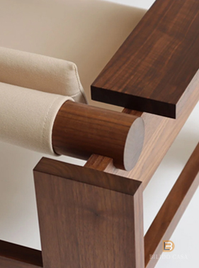 Custom seating detail with upholstered cushion and dark wooden armrest, blending comfort and craftsmanship.